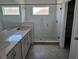 Bathroom featuring double sinks with quartz countertop and a glass-enclosed shower at 2980 Embark Trail, St Cloud, FL 34771