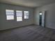 Spacious bedroom with new carpet, bright windows, and an ensuite bathroom at 2980 Embark Trail, St Cloud, FL 34771
