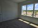 Comfortable carpeted bedroom filled with natural light from the large window at 2980 Embark Trail, St Cloud, FL 34771