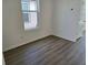 Cozy bedroom featuring a window, hardwood flooring, baseboards, and neutral paint at 2980 Embark Trail, St Cloud, FL 34771
