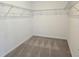 Walk-in closet with white walls, gray carpet, and wire shelving at 2980 Embark Trail, St Cloud, FL 34771