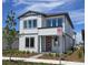 Charming two-story home featuring a modern design, beautiful landscaping, and a welcoming red door at 2980 Embark Trail, St Cloud, FL 34771