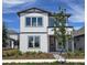 Charming two-story home featuring a modern design, beautiful landscaping, and a welcoming red door at 2980 Embark Trail, St Cloud, FL 34771
