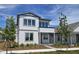 Charming two-story home featuring a modern design, beautiful landscaping, and a welcoming red door at 2980 Embark Trail, St Cloud, FL 34771