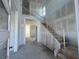 Spacious foyer with staircase, awaiting your personal touch to transform this blank canvas into a welcoming entrance at 2980 Embark Trail, St Cloud, FL 34771