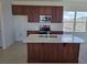 Kitchen with stainless steel appliances, an island with sink, and light countertops at 2980 Embark Trail, St Cloud, FL 34771