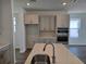 Modern kitchen with white cabinets, subway tile backsplash, stainless steel appliances, and hardwood floors at 2980 Embark Trail, St Cloud, FL 34771