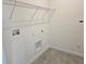 Well-lit laundry room features wire shelving, tile floors, and new hookups at 2980 Embark Trail, St Cloud, FL 34771