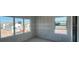 Light-filled living room with unfinished walls and large windows offering stunning views of the neighborhood at 2980 Embark Trail, St Cloud, FL 34771