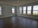Bright living room featuring multiple windows, hardwood flooring, and neutral paint at 2980 Embark Trail, St Cloud, FL 34771