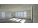 Bright, unfinished living room with expansive windows, awaiting your personal design to create a cozy retreat at 2980 Embark Trail, St Cloud, FL 34771