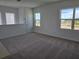 Loft area with plush carpet, multiple windows, and neutral paint at 2980 Embark Trail, St Cloud, FL 34771