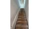 Under-construction staircase featuring wooden steps and white walls at 2980 Embark Trail, St Cloud, FL 34771