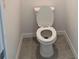 Close-up shot of a standard white toilet in a small bathroom with tiled floor at 2980 Embark Trail, St Cloud, FL 34771