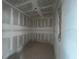 Compact walk-in closet featuring unfinished walls and a concrete floor, perfect for customization at 2980 Embark Trail, St Cloud, FL 34771
