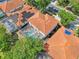 Stunning aerial view of a home with a screened-in pool and solar panels in a beautiful neighborhood at 332 Summer Place Loop, Clermont, FL 34714