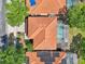 A bird's-eye view showcases homes with orange tile roofs, screened pools, and verdant landscaping at 332 Summer Place Loop, Clermont, FL 34714