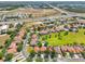 Wide aerial view of community, highlighting landscaped yards and tile roofs in a suburban setting at 332 Summer Place Loop, Clermont, FL 34714