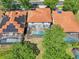 An aerial shot shows homes with orange roofs, screened pools, and tree coverage at 332 Summer Place Loop, Clermont, FL 34714