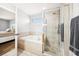 Bathroom features a soaking tub and a tiled shower with glass doors at 332 Summer Place Loop, Clermont, FL 34714