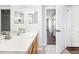 Bathroom with white countertop vanity, wood-look flooring, neutral walls, and open doorway to hall at 332 Summer Place Loop, Clermont, FL 34714
