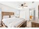 Bedroom with hardwood floors, neutral walls, ceiling fan, walk-in closet, a bed, and natural lighting at 332 Summer Place Loop, Clermont, FL 34714