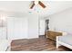 Bedroom featuring wood-look flooring, ceiling fan, closet, a dresser, and a twin bed with gray bedding at 332 Summer Place Loop, Clermont, FL 34714