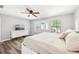 A neutral bedroom featuring hardwood floors, a ceiling fan, and a large white dresser at 332 Summer Place Loop, Clermont, FL 34714