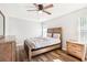Bedroom with wood-look flooring, ceiling fan, neutral walls, a bed with wood frame, and natural light at 332 Summer Place Loop, Clermont, FL 34714