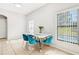 Bright dining area with modern table, stylish chairs, and sliding glass door to pool area at 332 Summer Place Loop, Clermont, FL 34714