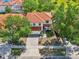 Aerial view of a two-story home with a tile roof, a two-car garage, and driveway parking at 332 Summer Place Loop, Clermont, FL 34714