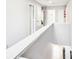 Bright, white hallway with multiple doors and access to the downstairs area at 332 Summer Place Loop, Clermont, FL 34714