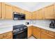 Updated kitchen features stainless steel appliances, light wood cabinetry, and stone countertops at 332 Summer Place Loop, Clermont, FL 34714