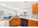 Open concept kitchen features stainless steel appliances, light wood cabinetry, and stone countertops at 332 Summer Place Loop, Clermont, FL 34714