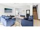 Open-concept living room with tile floors and comfortable furnishings at 332 Summer Place Loop, Clermont, FL 34714