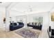 Open-concept living room with tile flooring, modern sofas, and sliding glass doors to backyard at 332 Summer Place Loop, Clermont, FL 34714