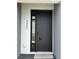 Modern black front door with contemporary hardware and house number at 3432 Tranquil Trl, Kissimmee, FL 34747