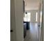 Hallway leading to kitchen with kitchen island and natural light at 3432 Tranquil Trl, Kissimmee, FL 34747