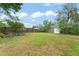 Large backyard featuring lush green grass and a wooden fence surrounding the property at 3631 Surrey Dr, Orlando, FL 32812