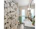 Bathroom with a double sink vanity, marble countertop, and decorative shower curtain at 3631 Surrey Dr, Orlando, FL 32812