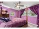 Bedroom with purple walls and a four-poster bed at 3631 Surrey Dr, Orlando, FL 32812