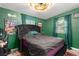 Bedroom with green walls and a tufted headboard bed at 3631 Surrey Dr, Orlando, FL 32812