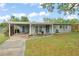 Charming single-story home with a carport, landscaped yard, and inviting curb appeal at 3631 Surrey Dr, Orlando, FL 32812