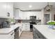 Bright, updated kitchen features white cabinets, quartz countertops, and stainless steel appliances at 3631 Surrey Dr, Orlando, FL 32812