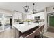 Modern kitchen with a large island, white cabinets, and stainless steel appliances at 3631 Surrey Dr, Orlando, FL 32812