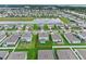 Aerial view showcasing a residential area with water views, surrounded by lush green landscaping at 3970 Clipstone Pl, Sanford, FL 32773