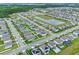 Wide aerial view of a residential neighborhood featuring ponds and green spaces between residences at 3970 Clipstone Pl, Sanford, FL 32773