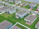 Aerial view of a well-manicured neighborhood featuring green lawns, palm trees, and a peaceful community at 3970 Clipstone Pl, Sanford, FL 32773