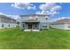 Large backyard with covered patio, ample space for outdoor activities, and serene surroundings at 3970 Clipstone Pl, Sanford, FL 32773