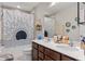 Bathroom with double vanity, bath tub, and shower with modern shower curtain at 3970 Clipstone Pl, Sanford, FL 32773